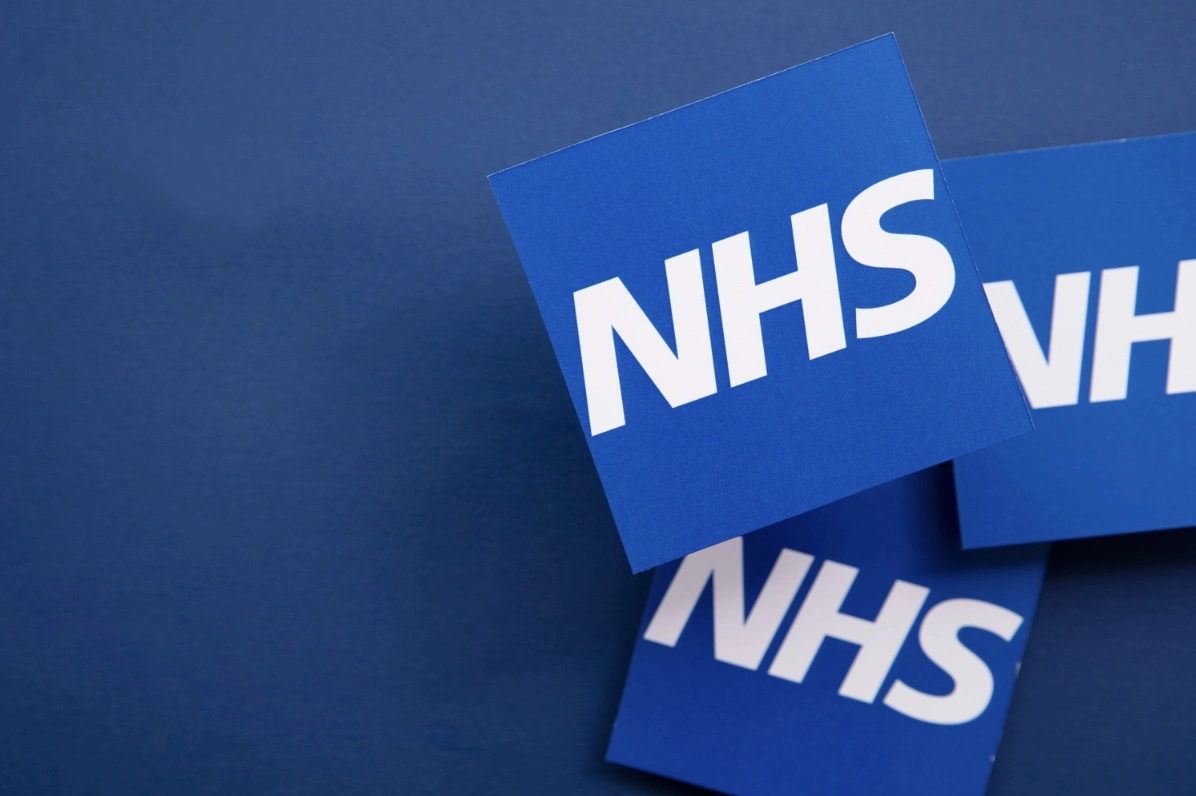 NHS logos on a blue background featuring Saxenda on NHS.